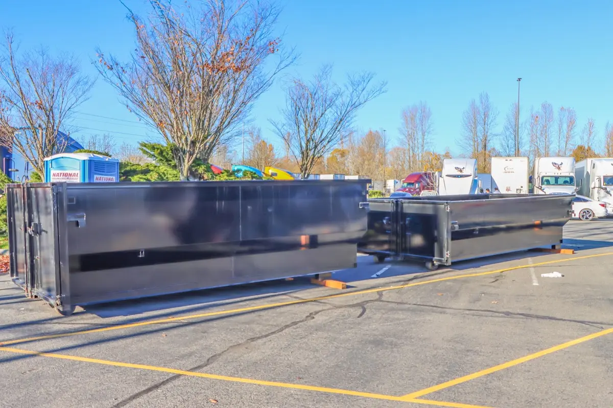 Professional dumpster rental service with roll-off container on residential driveway in Emmaus